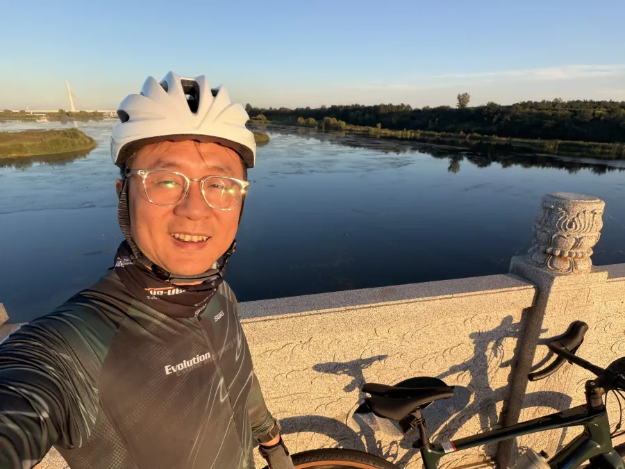 Hommer Zhao cycling by the Hutuo River in northern China at sunset