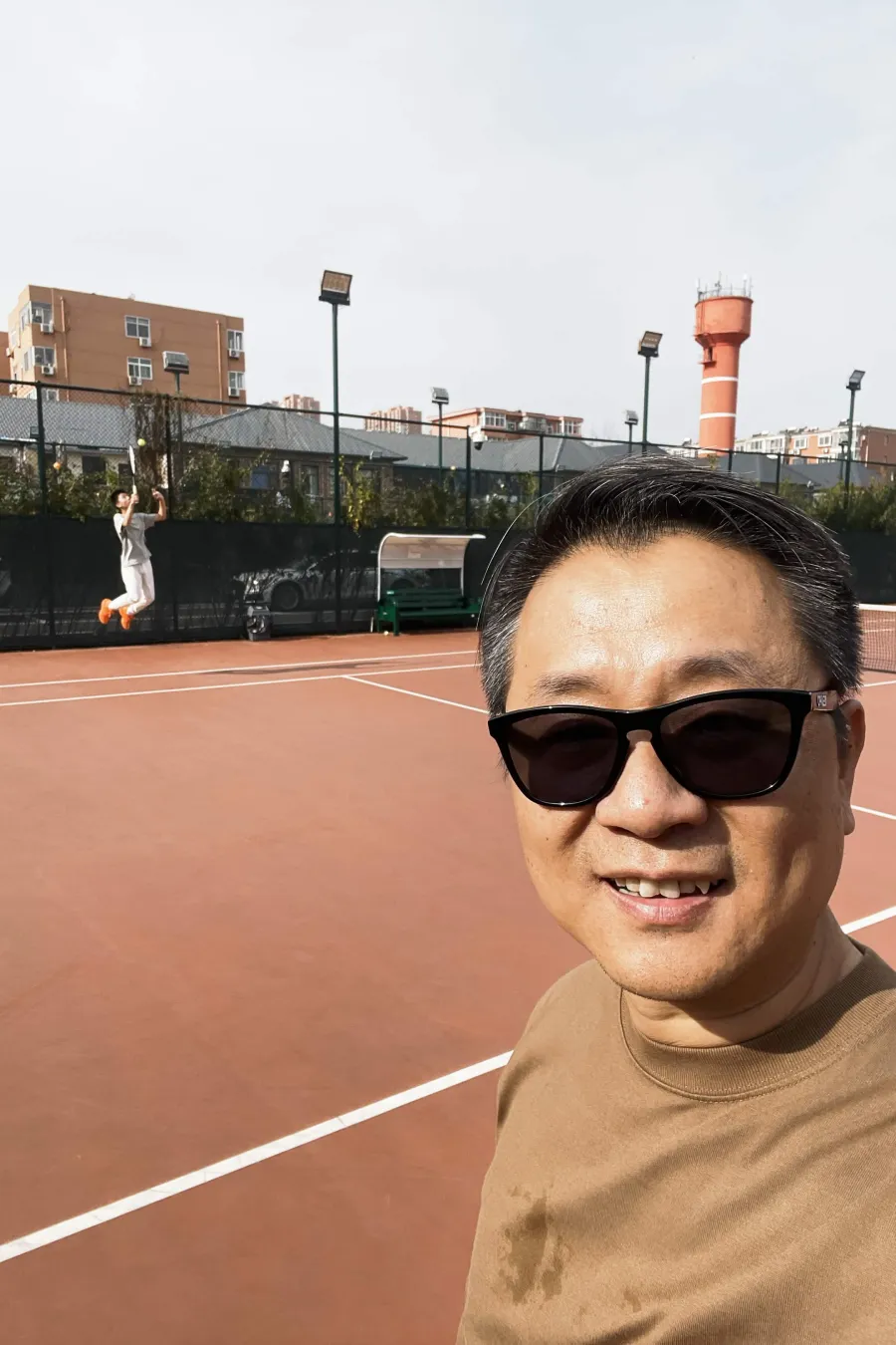Hommer Zhao playing tennis with his son